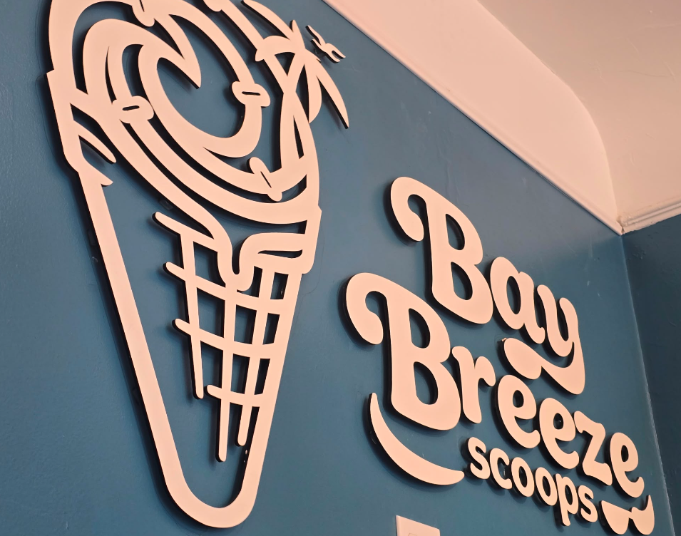 The original Bay Breeze Scoops wall logo inside the shop
